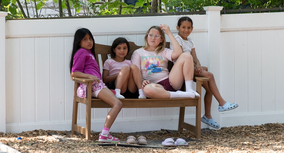 Girls on a bench at Mother Hubbard Preschool