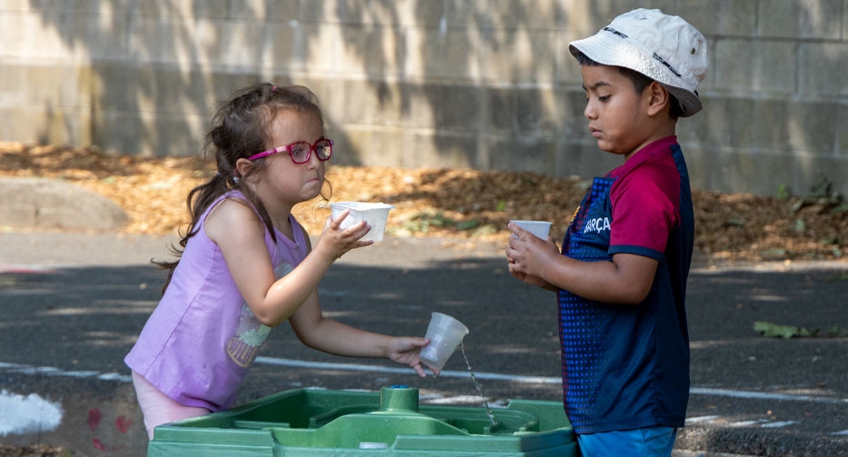 Playing at the water table at Mother Hubbard Preschool