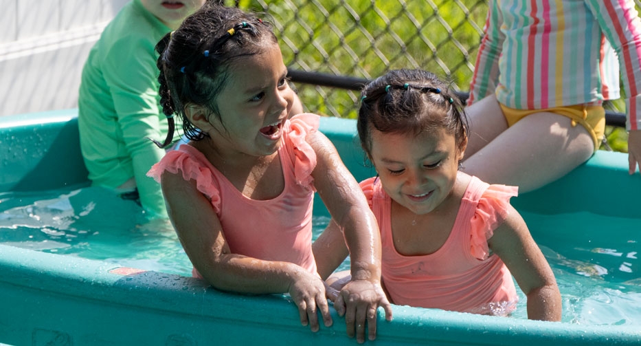 Girls playing in the pool at Mother Hubbard Preschool